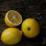 Top view of fresh lemons on a rustic wooden table, perfect for natural themes.
